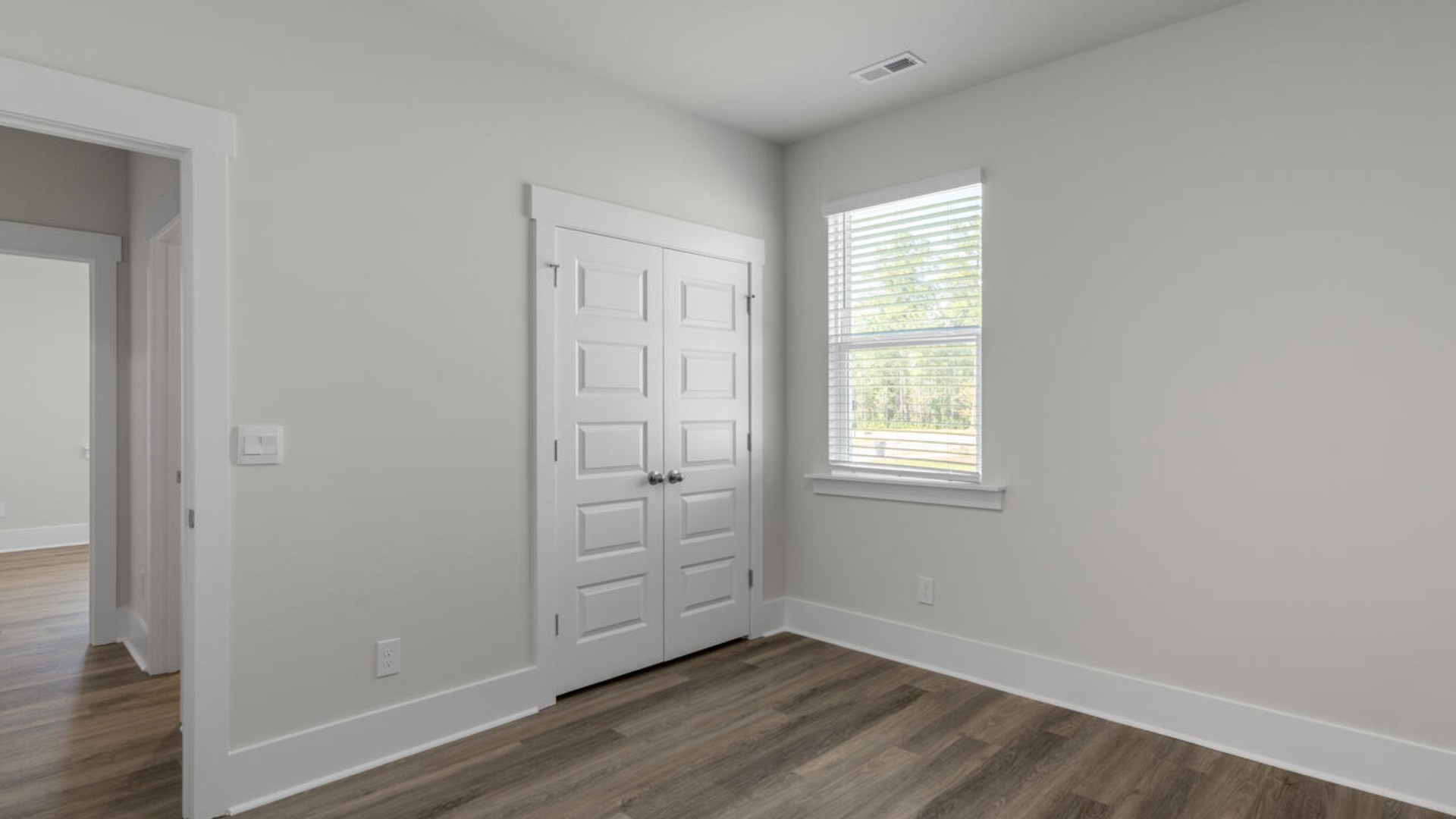 The split bedroom plan creates a private primary bedroom suite featuring two walk-in closets and a spacious en suite bath. There are three bedrooms at the front of the home with a full bathroom as well as laundry room.