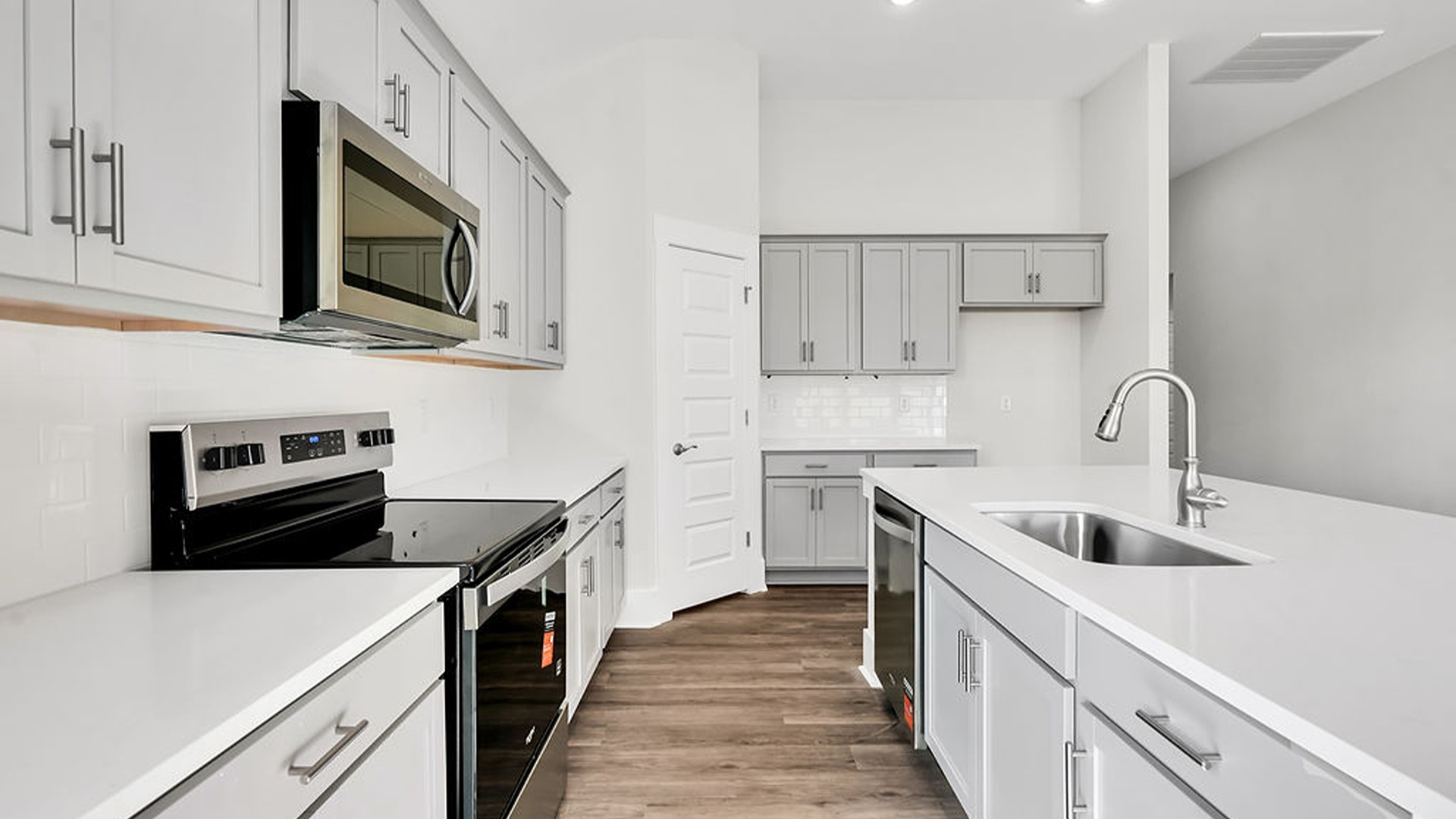 The Litchfield is a perfect home for relaxation and entertaining with a very open floor plan, 11-foot-high ceiling, and a large gourmet kitchen with granite countertops, tile backsplash, walk-in pantry, and stainless-steel appliances in kitchen.