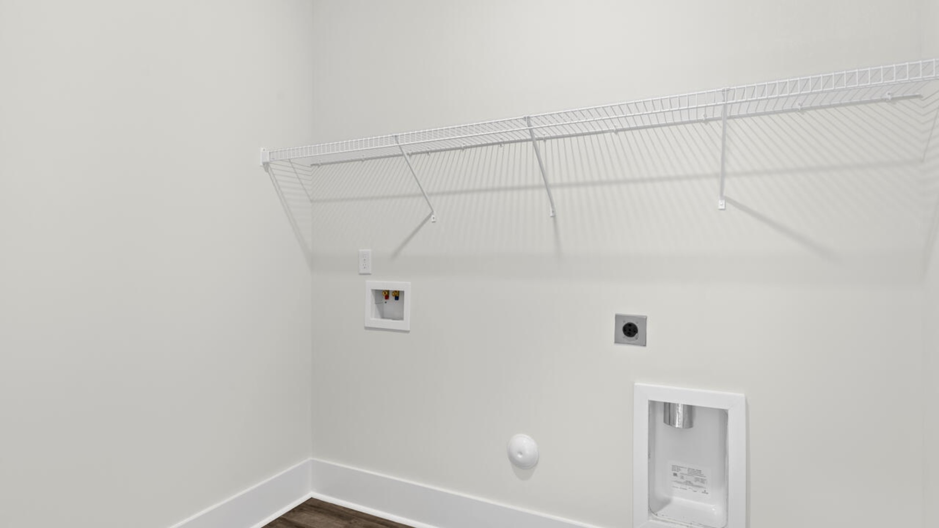 The split bedroom plan creates a private primary bedroom suite featuring two walk-in closets and a spacious en suite bath. There are three bedrooms at the front of the home with a full bathroom as well as laundry room.
