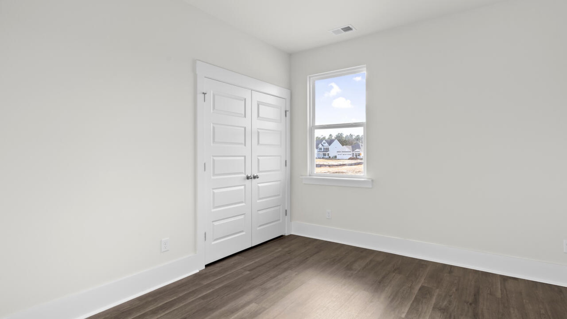 The split bedroom plan creates a private primary bedroom suite featuring two walk-in closets and a spacious en suite bath. There are three bedrooms at the front of the home with a full bathroom as well as laundry room.