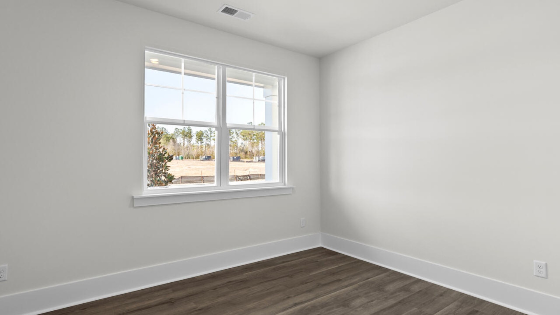 The split bedroom plan creates a private primary bedroom suite featuring two walk-in closets and a spacious en suite bath. There are three bedrooms at the front of the home with a full bathroom as well as laundry room.