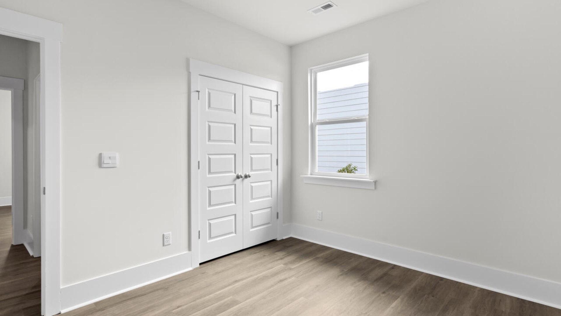 The split bedroom plan creates a private primary bedroom suite featuring two walk-in closets and a spacious en suite bath. There are three bedrooms at the front of the home with a full bathroom as well as laundry room.