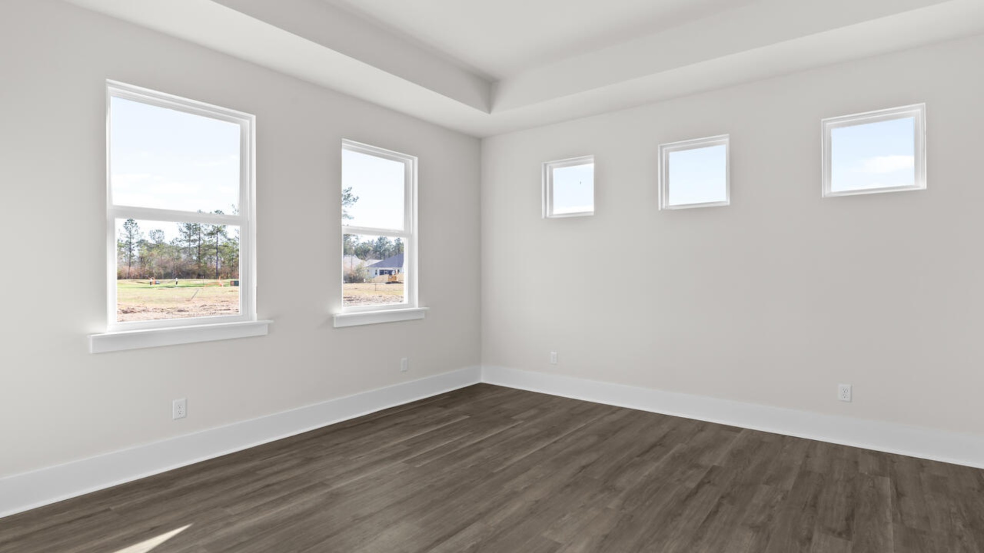 The split bedroom plan creates a private primary bedroom suite featuring two walk-in closets and a spacious en suite bath. There are three bedrooms at the front of the home with a full bathroom as well as laundry room.