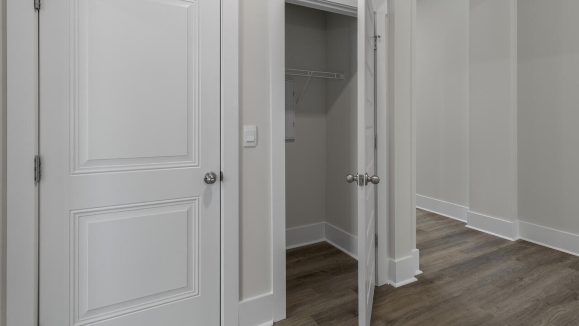 The split bedroom plan creates a private primary bedroom suite featuring two walk-in closets and a spacious en suite bath. There are three bedrooms at the front of the home with a full bathroom as well as laundry room.
