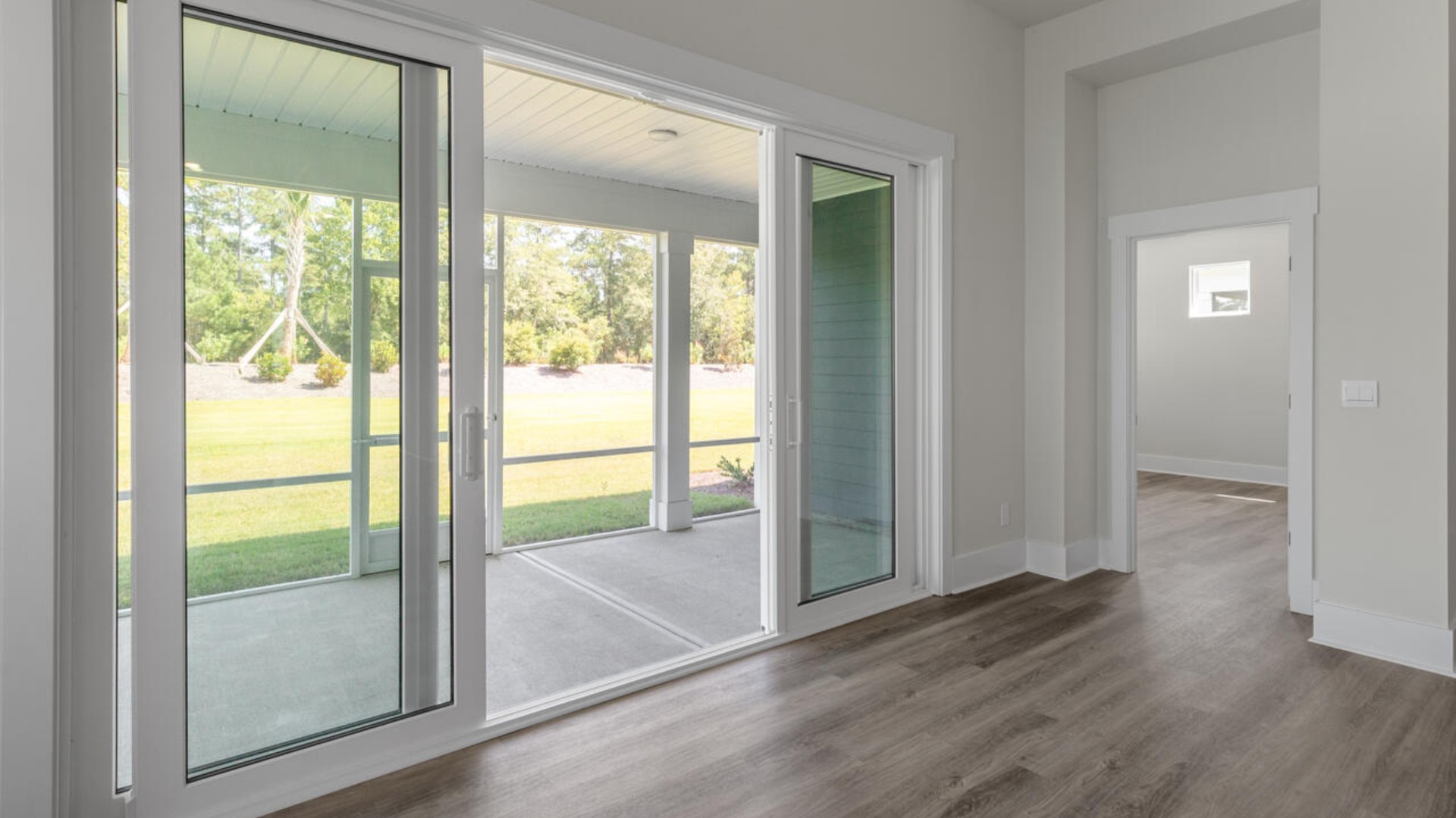 The split bedroom plan creates a private primary bedroom suite featuring two walk-in closets and a spacious en suite bath. There are three bedrooms at the front of the home with a full bathroom as well as laundry room.