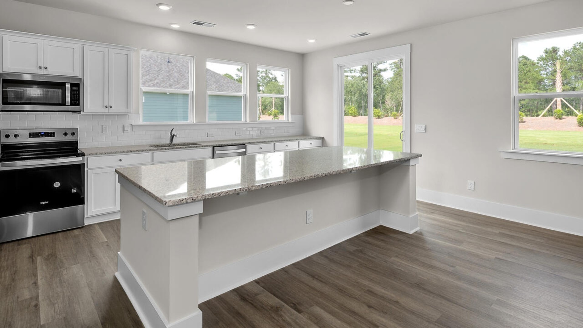 The kitchen features shaker-style cabinets and beautiful quartz countertops. The kitchen island is the perfect size for meal prep with a built-in sink and dishwasher. There’s also a large pantry and stainless steel appliances for function and style.
