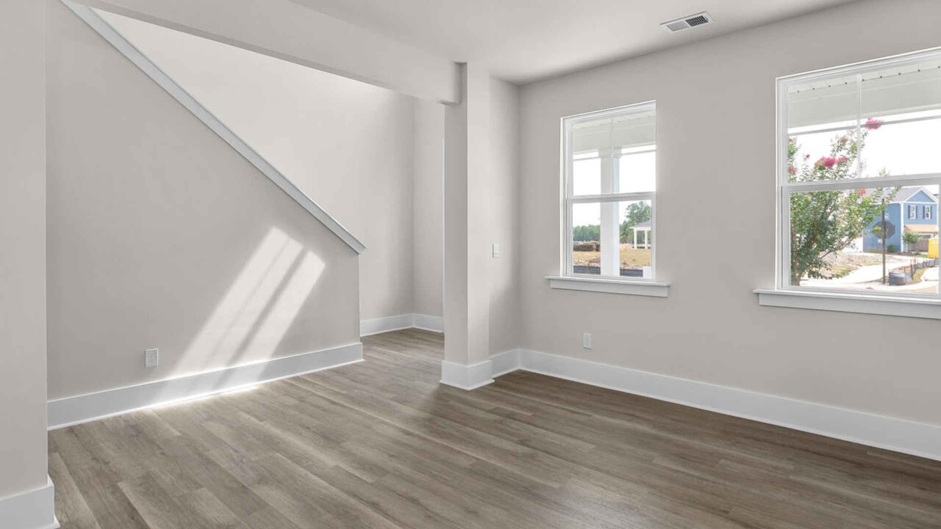 eaturing a formal dining room adjoining the kitchen, large island with granite countertops, and open concept living space.