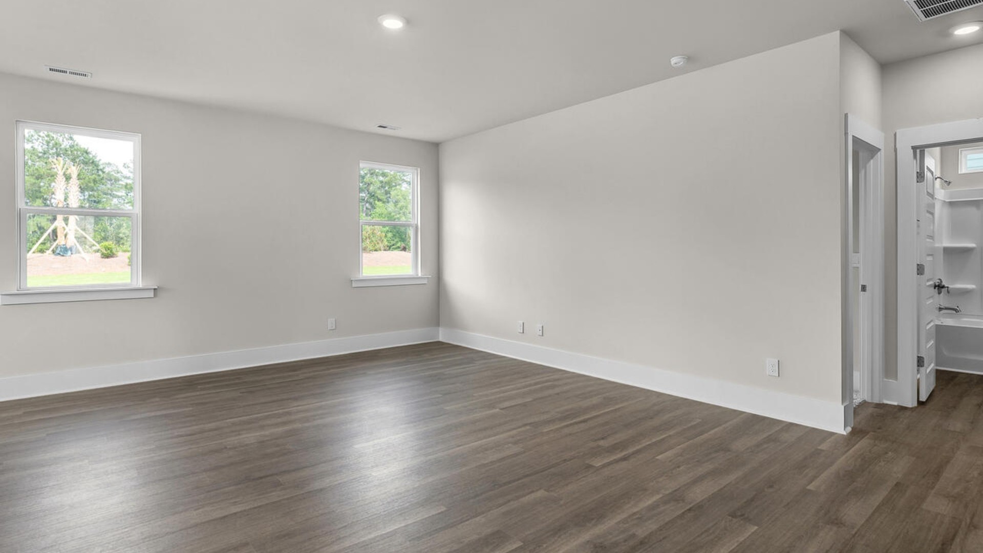 eaturing a formal dining room adjoining the kitchen, large island with granite countertops, and open concept living space.