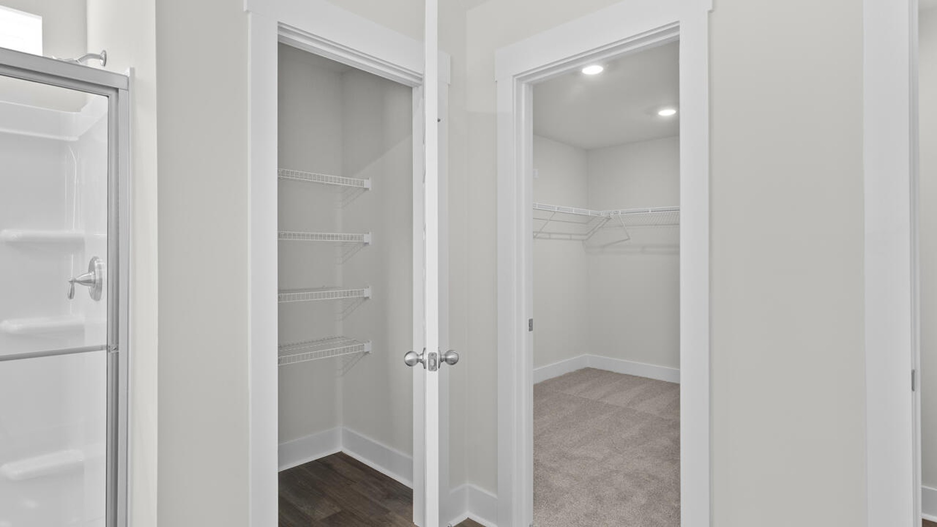 The primary suite features a walk-in closet, trayed ceiling, a step-in 5-foot shower, dual vanity with granite countertops, and natural light in the bathroom.