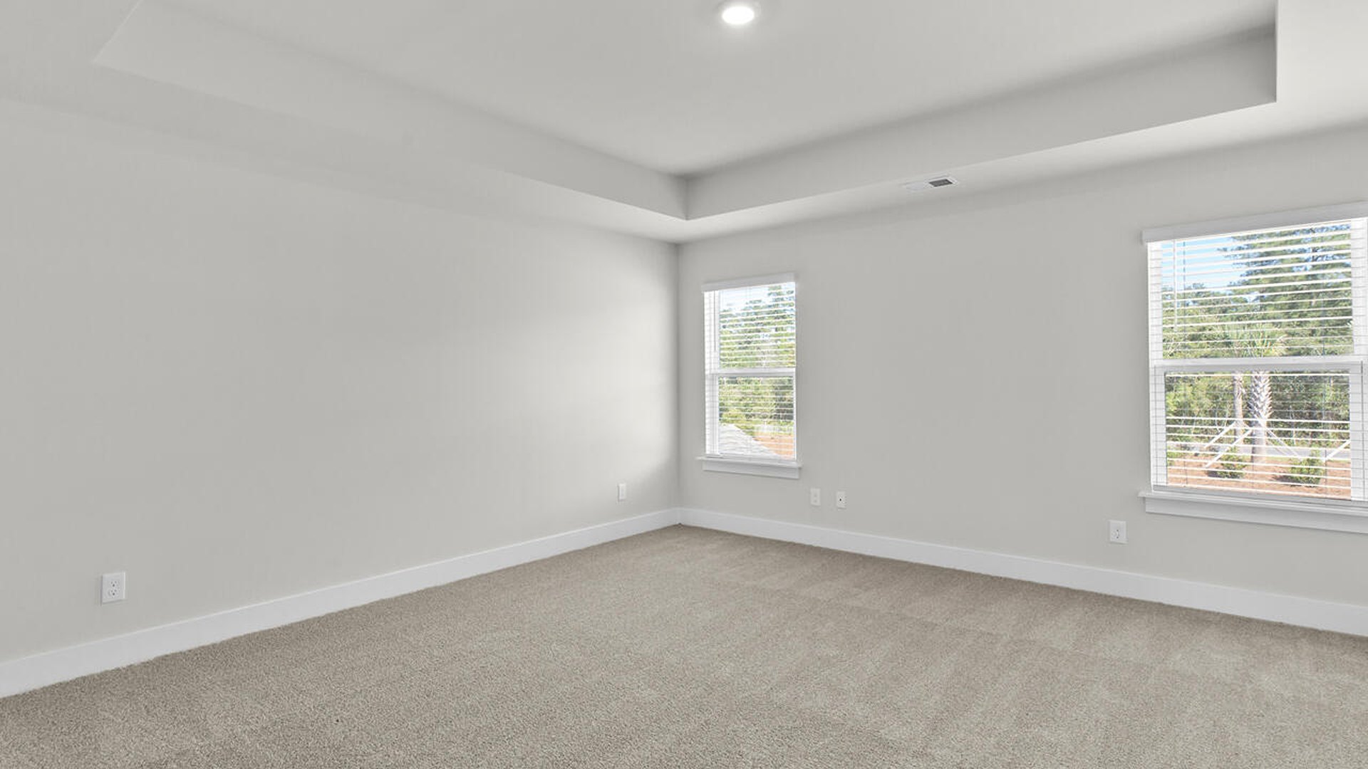 The primary suite features a sitting room, walk-in closet, trayed ceiling, a step-in 5-foot shower, dual vanity with granite countertops, and natural light in the bathroom.