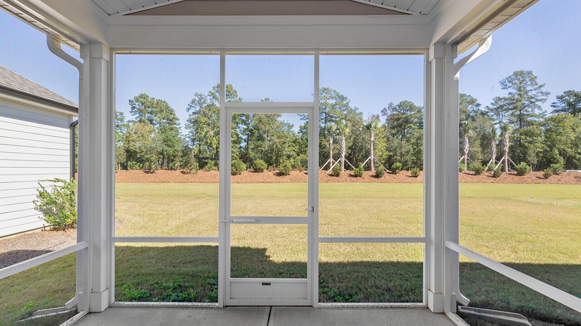 There is a screened-in porch located off the kitchen, as well as a guest suite on the first floor.