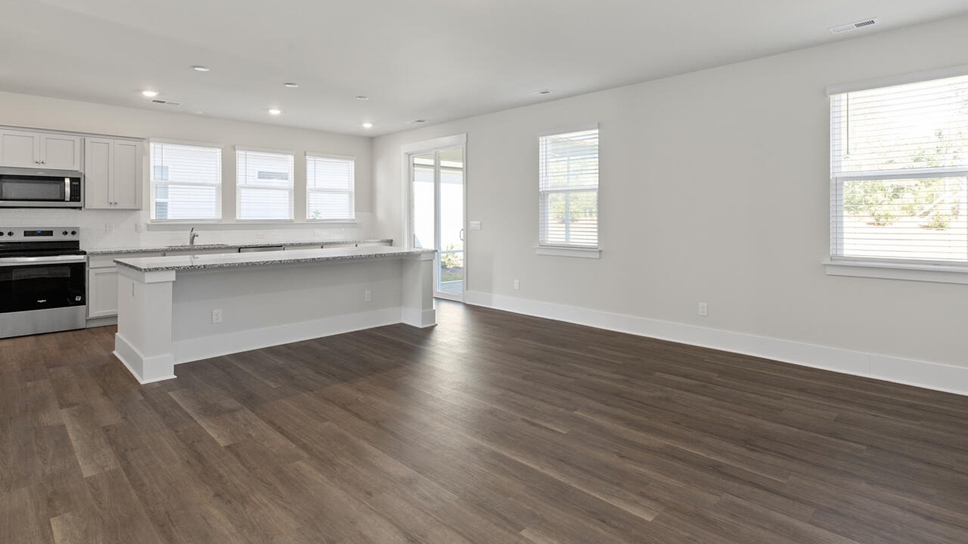 Featuring a formal dining room adjoining the kitchen, large island with granite countertops, and open concept living space.