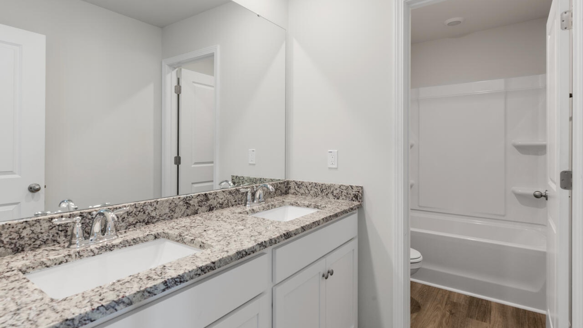 The primary suite spans the whole back of the home with a sitting room. The primary suite bath features a step-in 5' shower and a dual vanity. Large upstairs loft with closets for storage. Upstairs you are greeted by a convenient loft, a laundry room, and the primary retreat, which boasts the suite's sitting room and substantial walk-in closet.