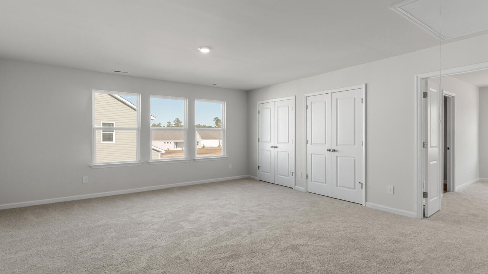 Large upstairs loft with closets for storage. Upstairs you are greeted by a convenient loft, a laundry room, and the primary retreat, which boasts the suite's sitting room and substantial walk-in closet