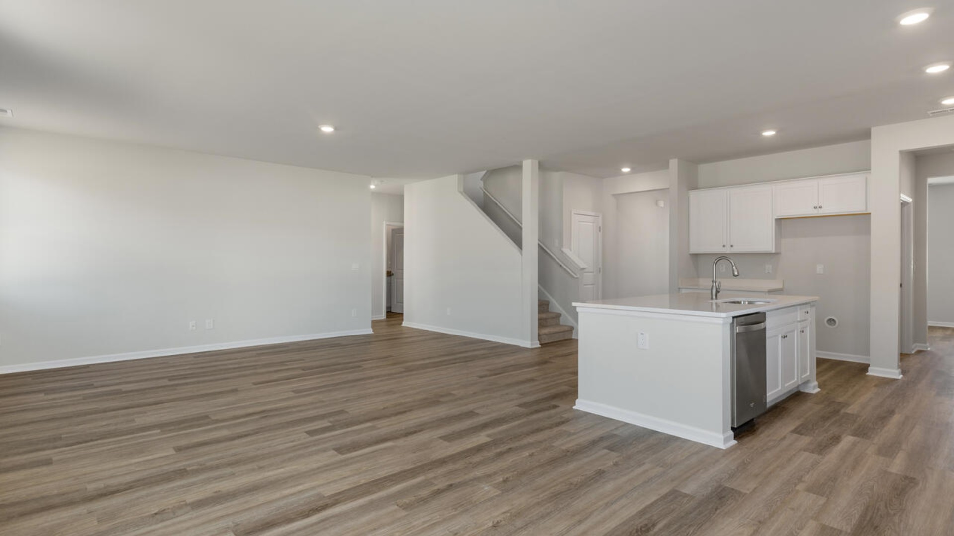 Downstairs there is a formal dining room that leads into a large butler's pantry then the kitchen. The kitchen is loaded with features including a quartz island, 36'' cabinets, stainless-steel appliances and opens up to the living room.