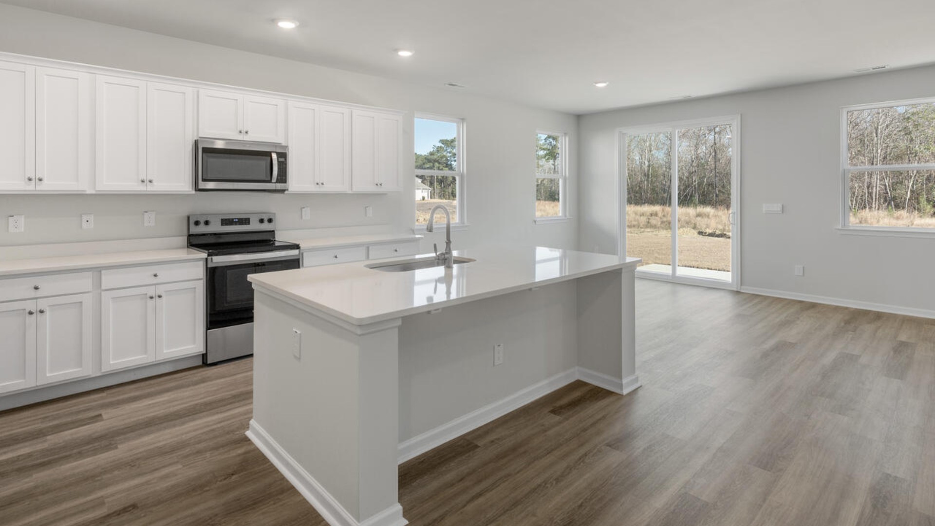 The butler’s pantry leads you into the massive kitchen and offers elegance and convenience, perfect for hosting dinner parties or holiday meals. The kitchen is open and expansive with a large island that overlooks the living room and the eat in kitchen area. Tucked away behind the living room is a private downstairs bedroom and full bathroom.