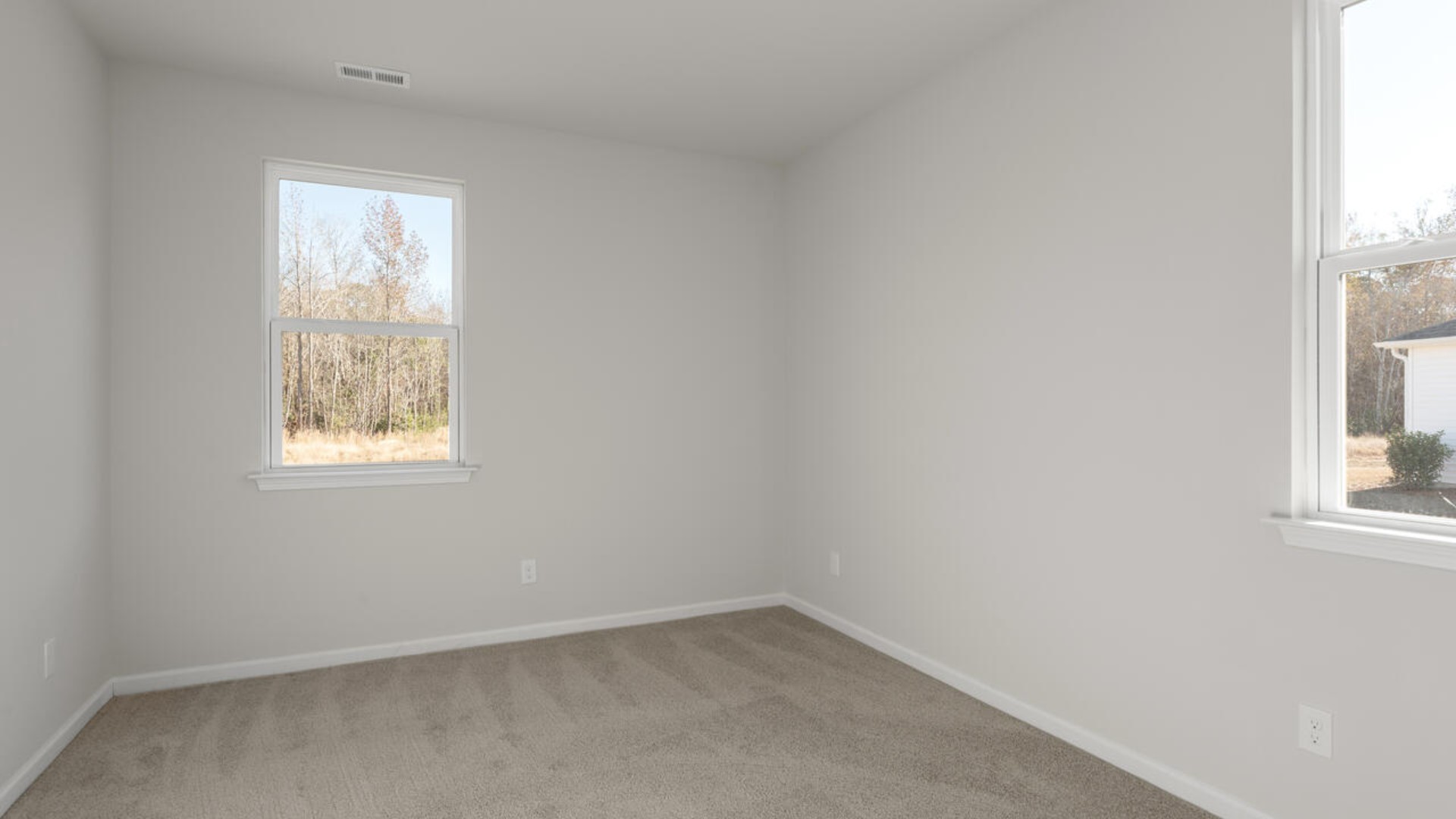 . The large loft in the center of the second floor separates the primary suite from secondary bedrooms and offers endless possibilities—use it as a playroom, media room, or fitness area. The secondary bedrooms are spacious.