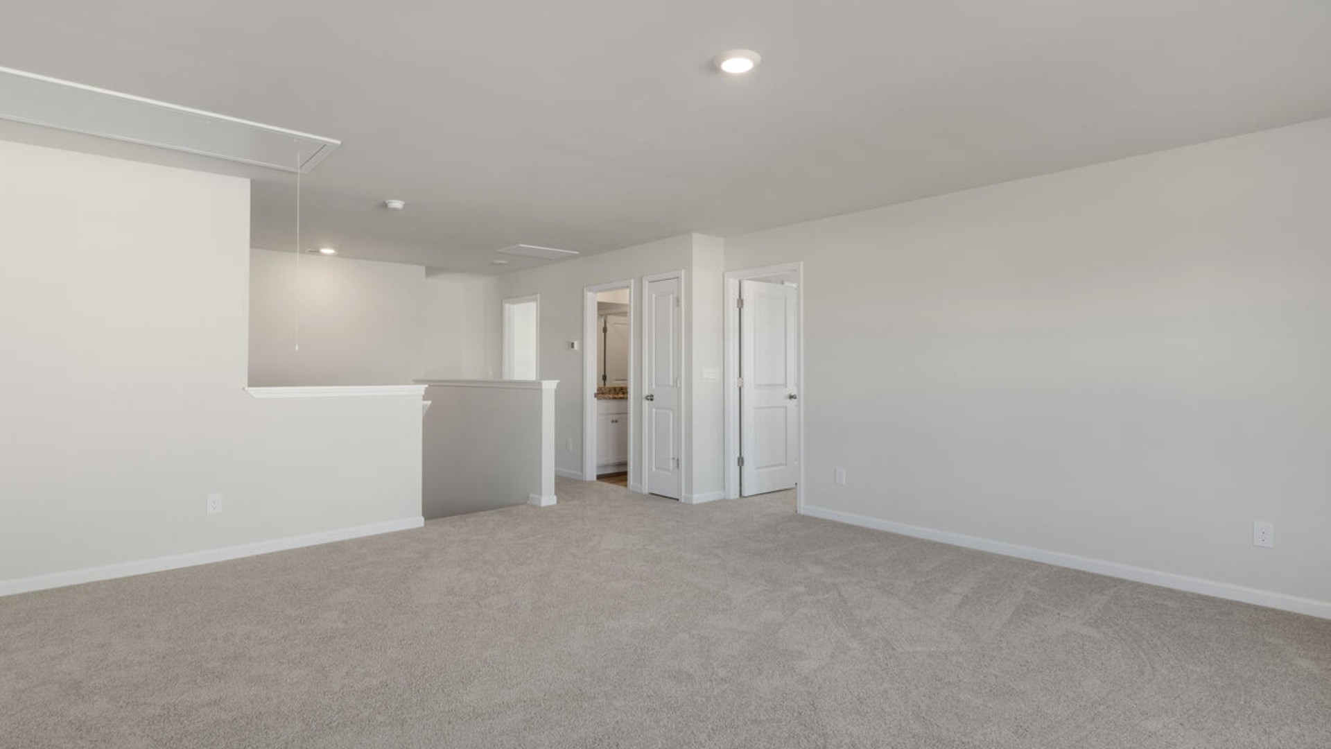 The primary suite spans the whole back of the home with a sitting room. The primary suite bath features a step-in 5' shower and a dual vanity.