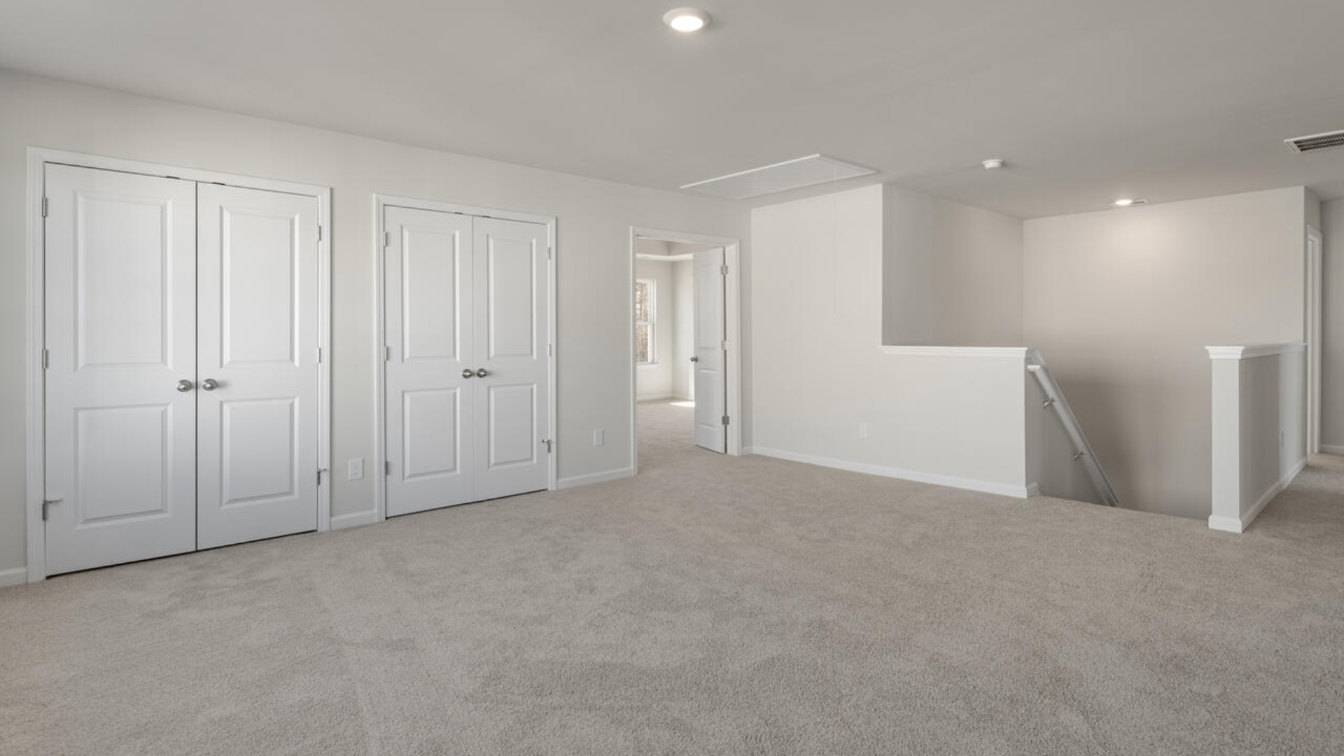 The primary suite spans the whole back of the home with a sitting room. The primary suite bath features a step-in 5' shower and a dual vanity.