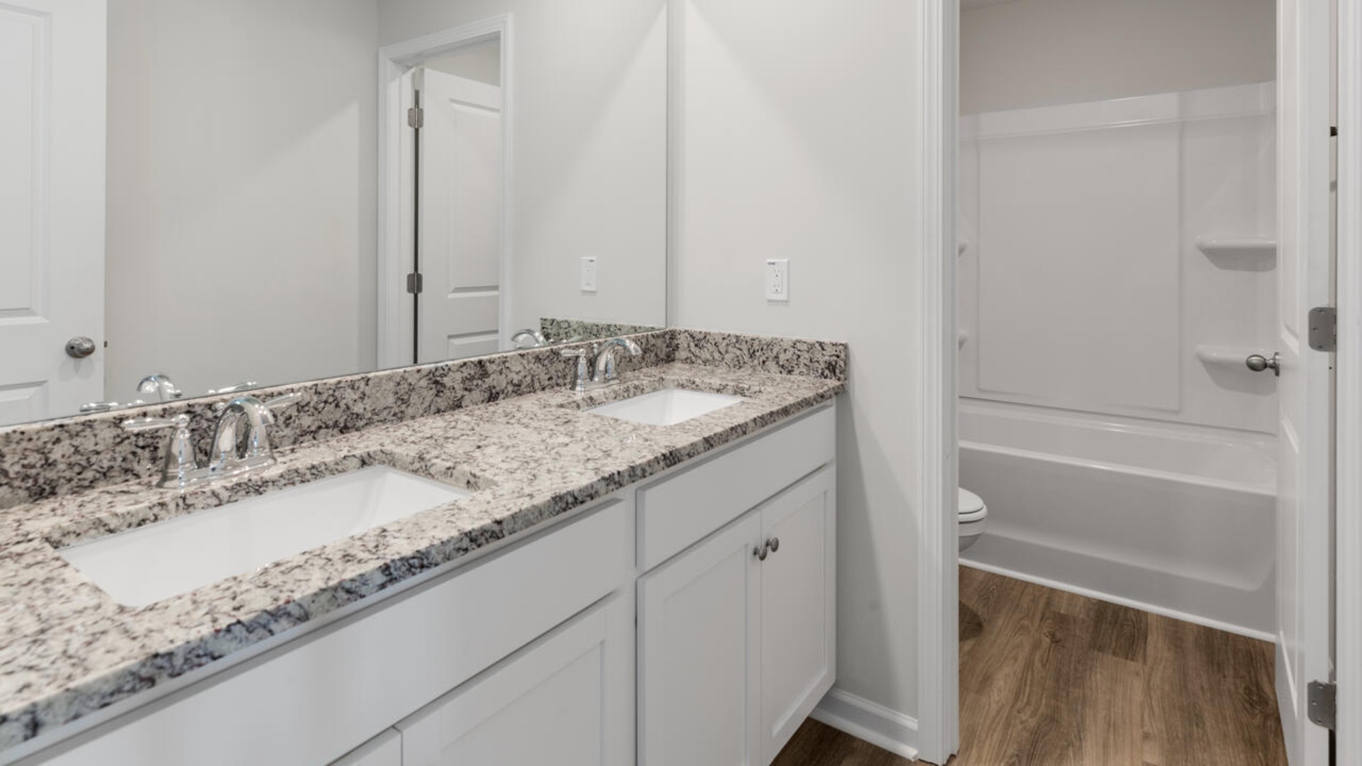 Upstairs you are greeted by a convenient loft, a laundry room, and the primary retreat, which boasts the suite's sitting room and substantial walk-in closet.