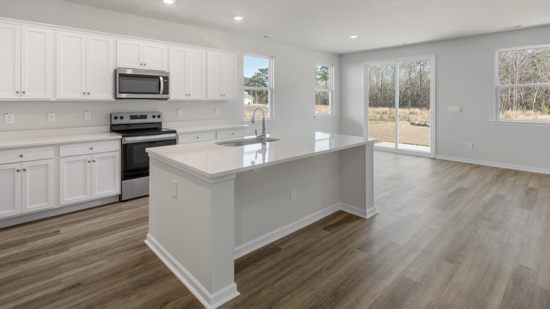 The kitchen is loaded with features including a granite island, 36'' cabinets, stainless-steel appliances and opens up to the living room.