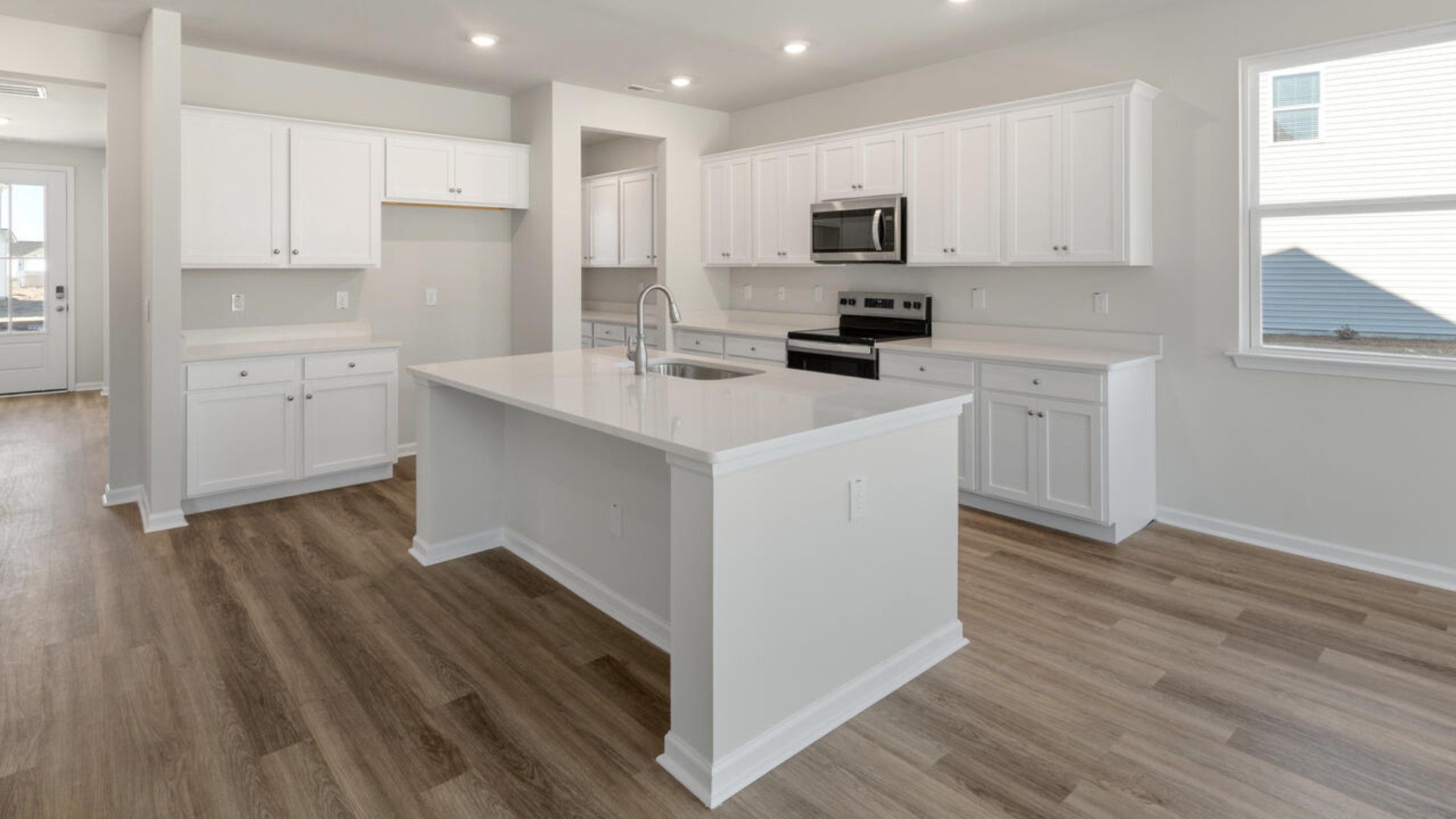 The kitchen is loaded with features including a granite island, 36'' cabinets, stainless-steel appliances and opens up to the living room.