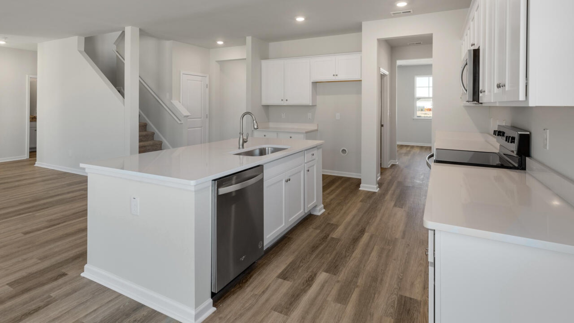 The kitchen is loaded with features including a granite island, 36'' cabinets, stainless-steel appliances and opens up to the living room.