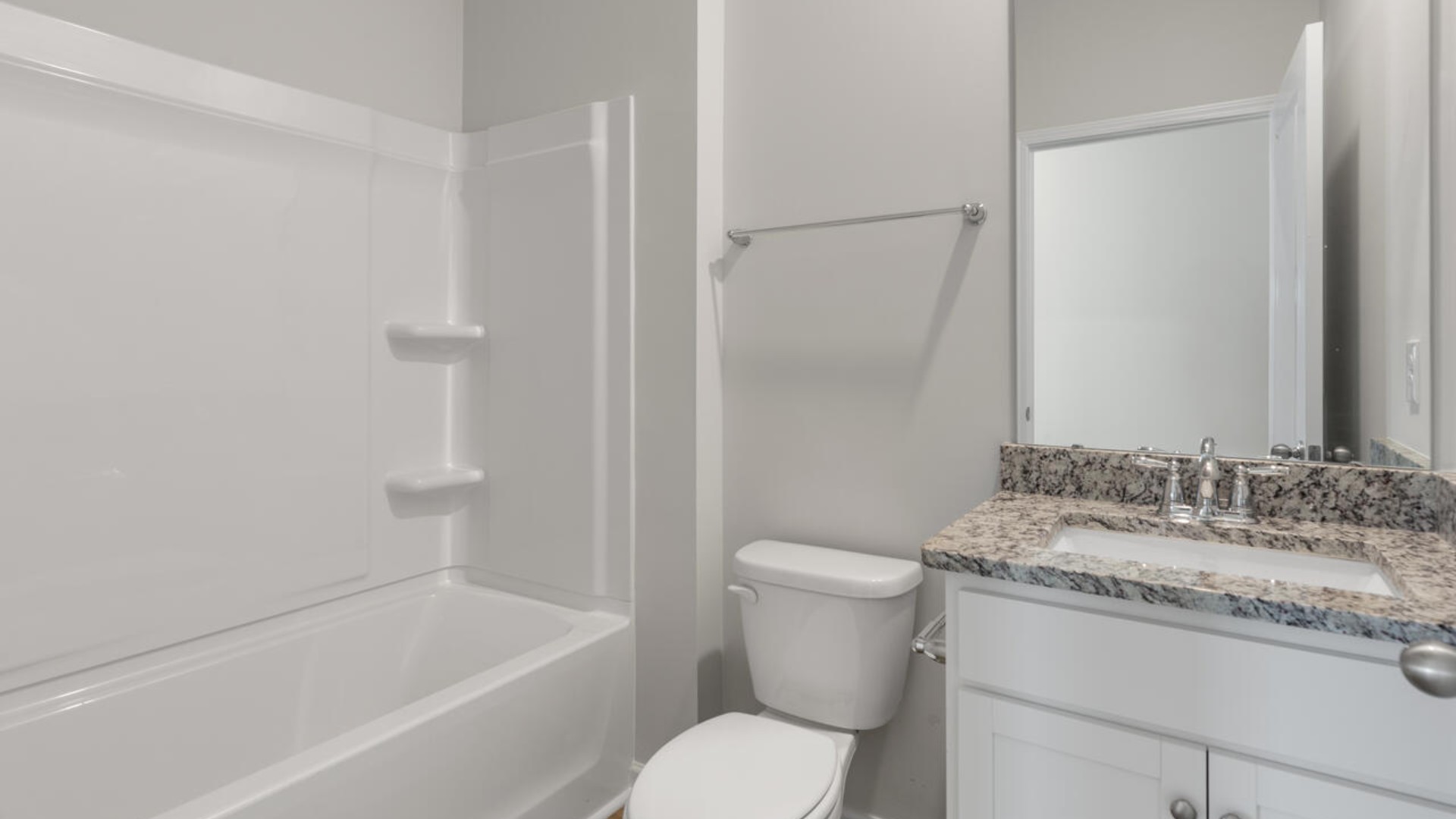 The primary suite spans the whole back of the home with a sitting room. The primary suite bath features a step-in 5' shower and a dual vanity.