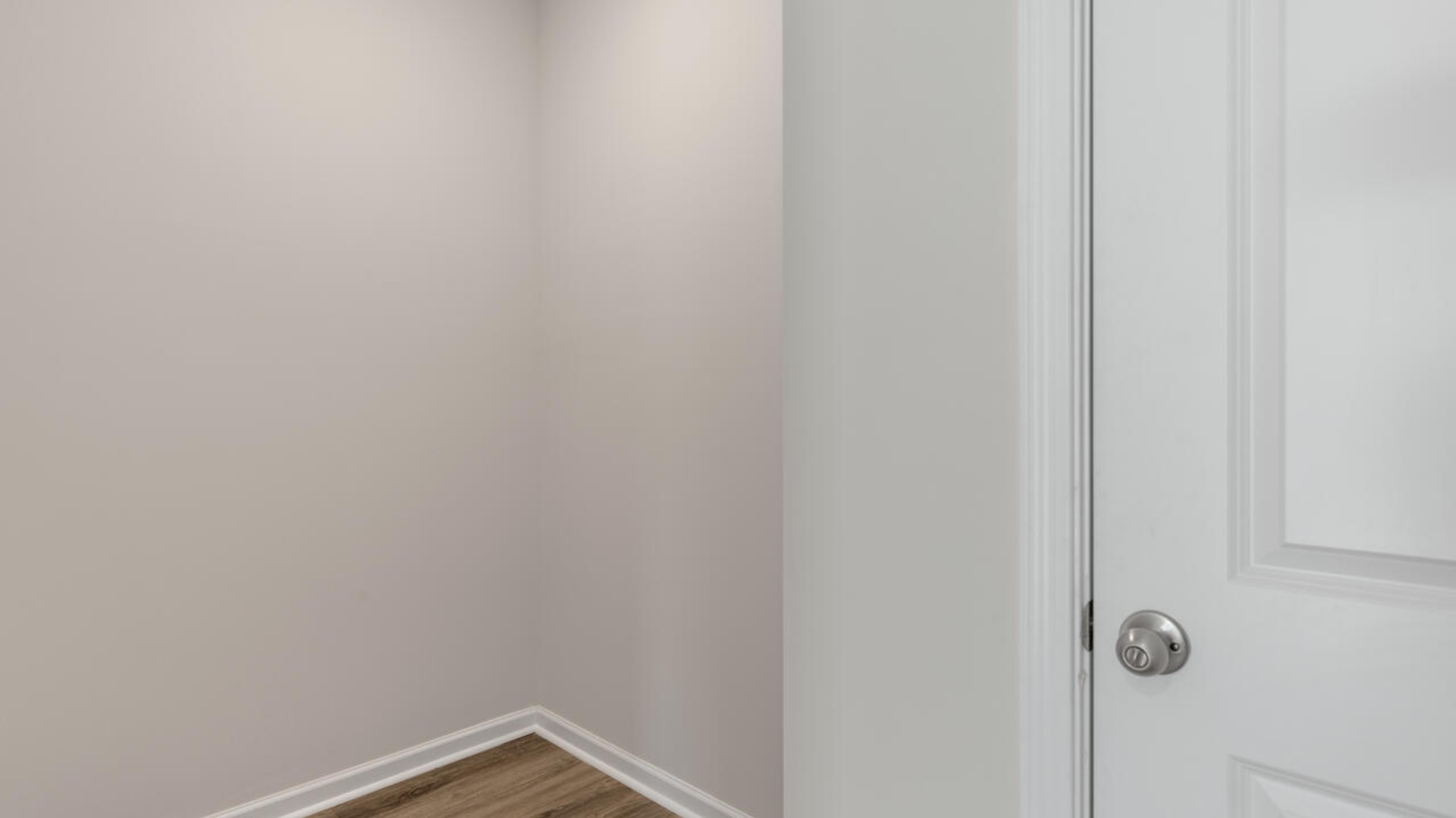 The primary suite spans the whole back of the home with a sitting room. The primary suite bath features a step-in 5' shower and a dual vanity.