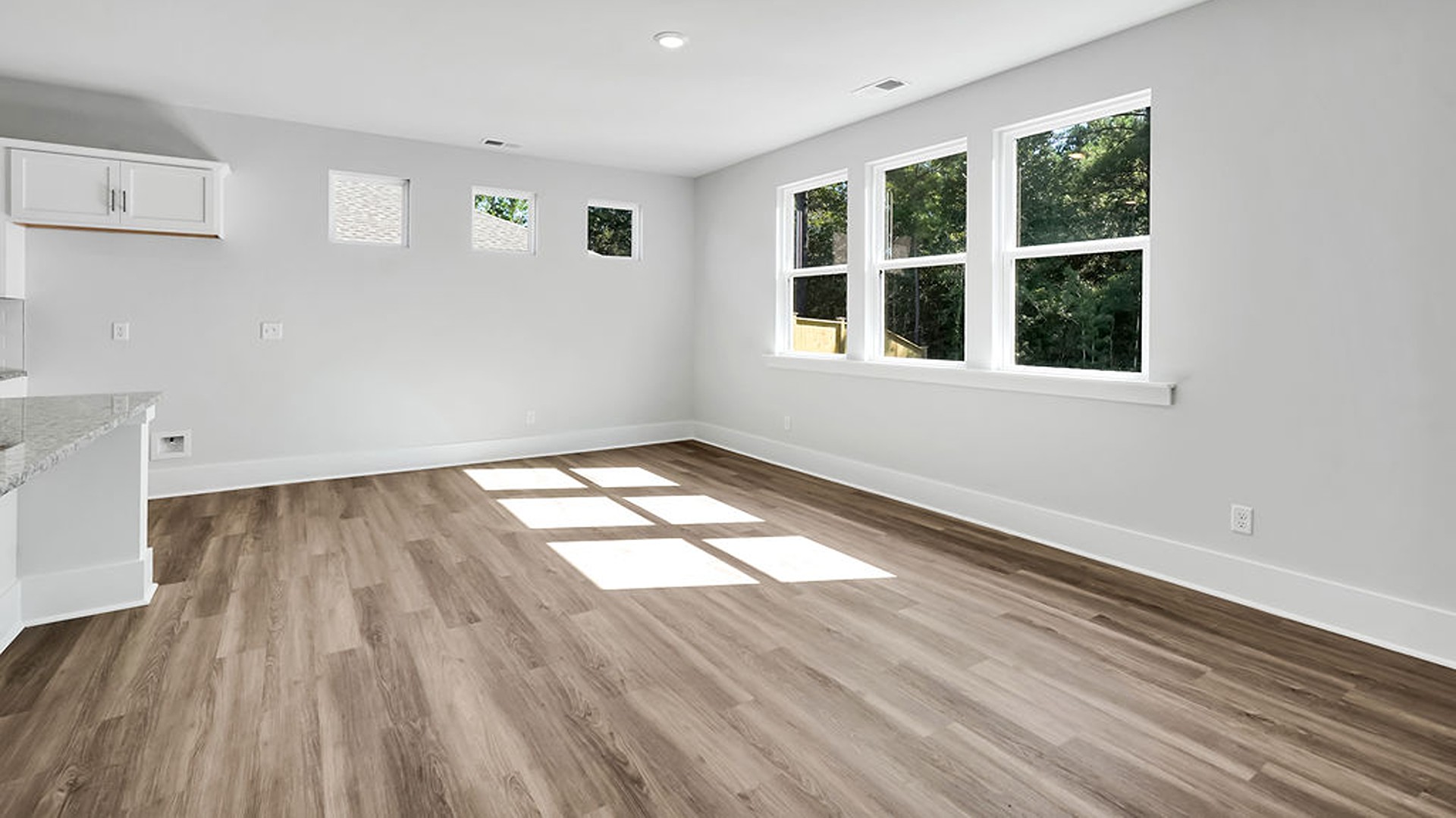 The gourmet kitchen serves as the focal point, anchored by a grand center island with seating, a walk-in pantry, and a seamless flow into the living room—complete with an optional fireplace.