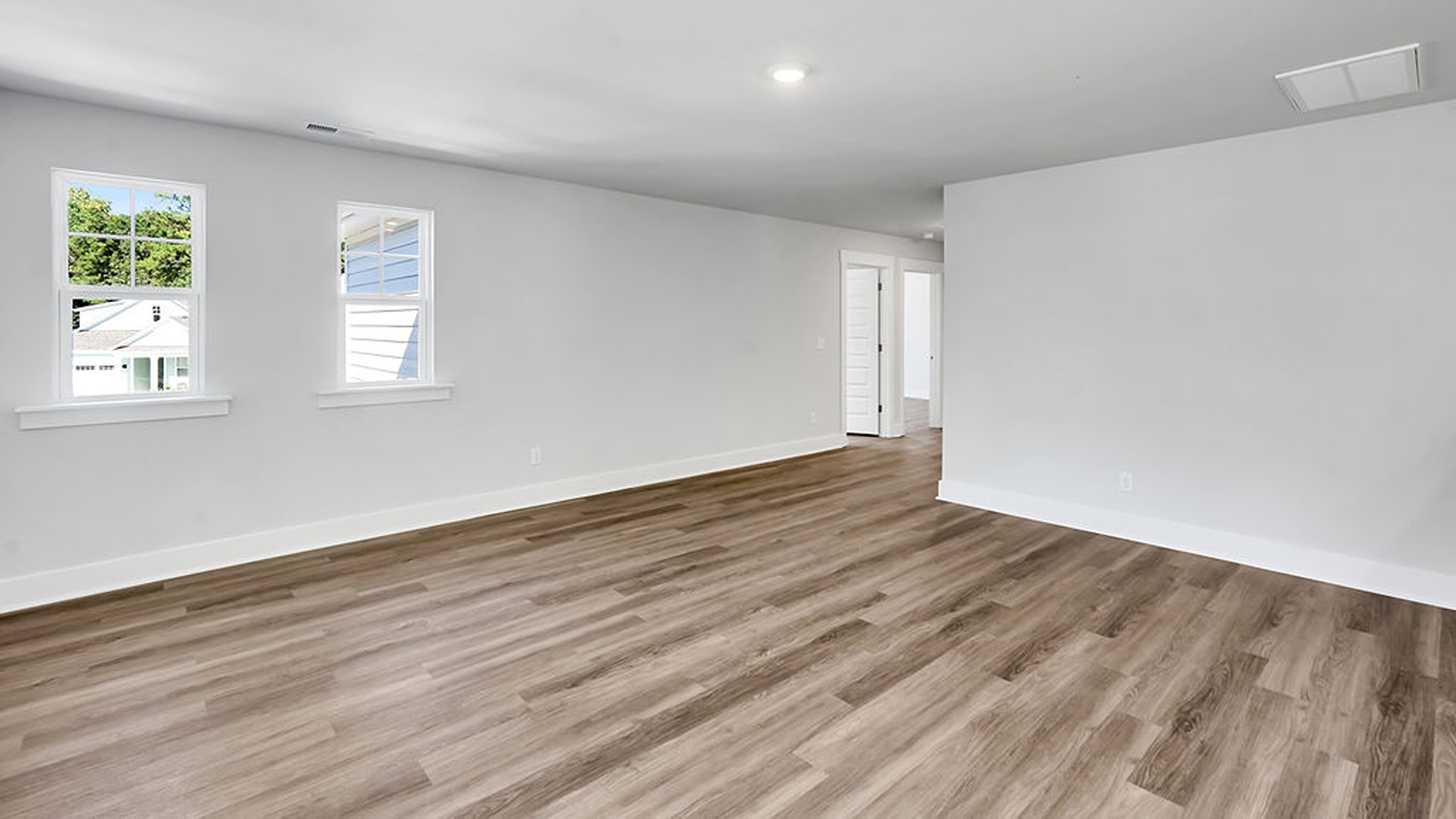 The gourmet kitchen serves as the focal point, anchored by a grand center island with seating, a walk-in pantry, and a seamless flow into the living room—complete with an optional fireplace.
