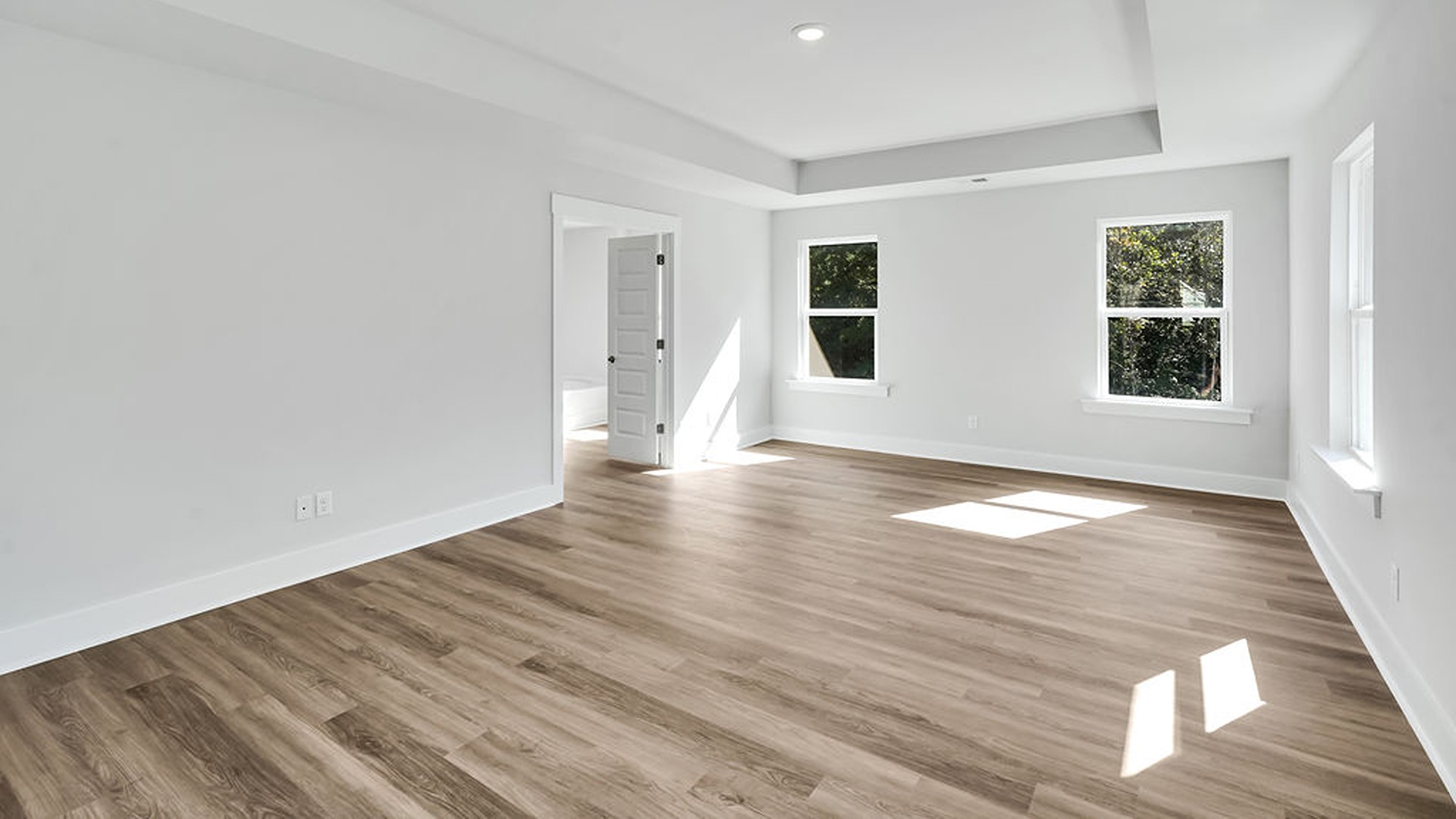 The gourmet kitchen serves as the focal point, anchored by a grand center island with seating, a walk-in pantry, and a seamless flow into the living room—complete with an optional fireplace.
