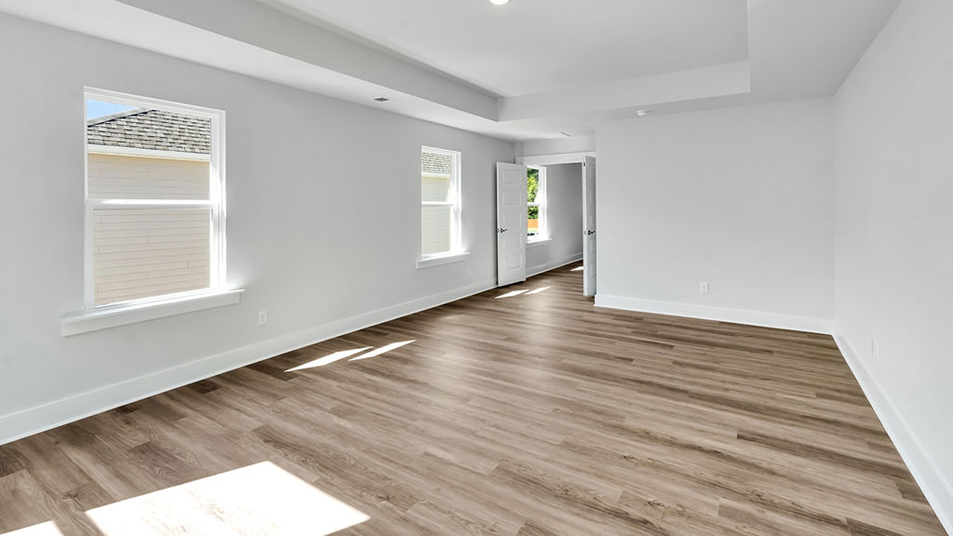 The gourmet kitchen serves as the focal point, anchored by a grand center island with seating, a walk-in pantry, and a seamless flow into the living room—complete with an optional fireplace.