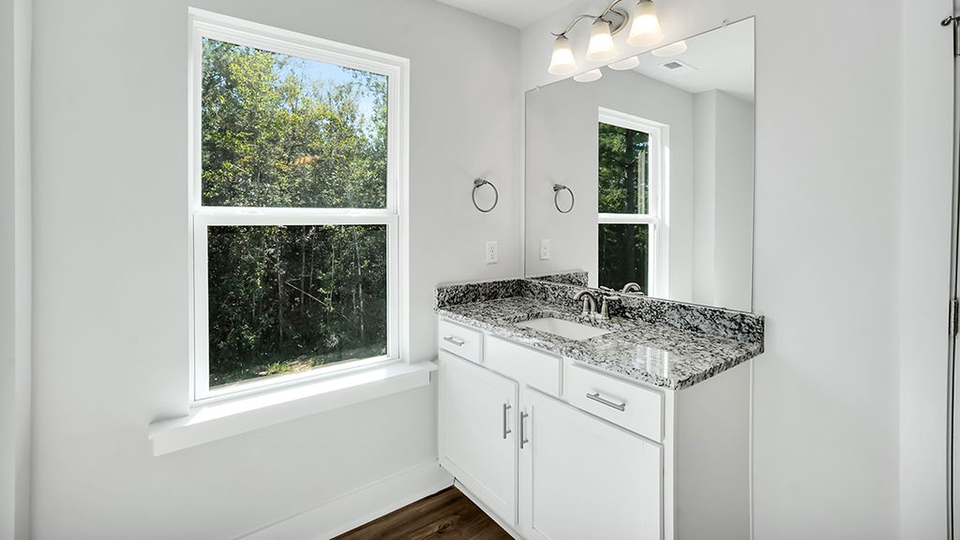 The main level also uniquely includes a private secondary bedroom away from the traffic, making it an ideal guest suite or quiet home office, conveniently adjacent to a full secondary bathroom and a nearby powder room.