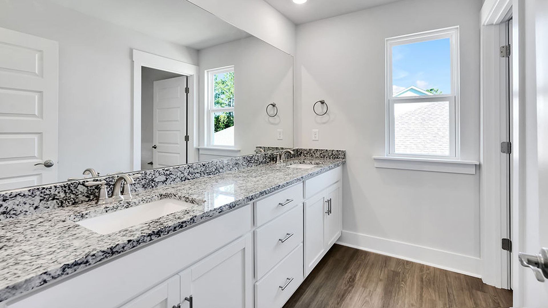 Upstairs, the crown jewel is the massive Primary Bedroom, a true owner’s getaway featuring tray ceiling details, abundant natural light, a spa-inspired bath with double vanities, and an oversized Walk-In Closet with integrated attic access.