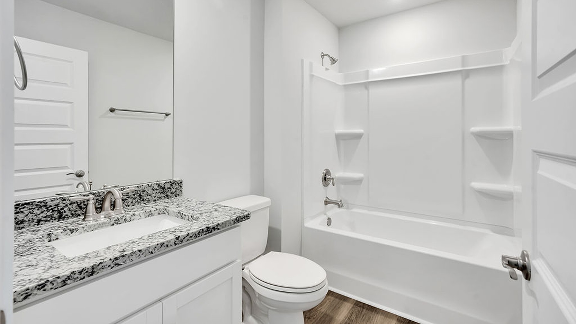 Upstairs, the crown jewel is the massive Primary Bedroom, a true owner’s getaway featuring tray ceiling details, abundant natural light, a spa-inspired bath with double vanities, and an oversized Walk-In Closet with integrated attic access.