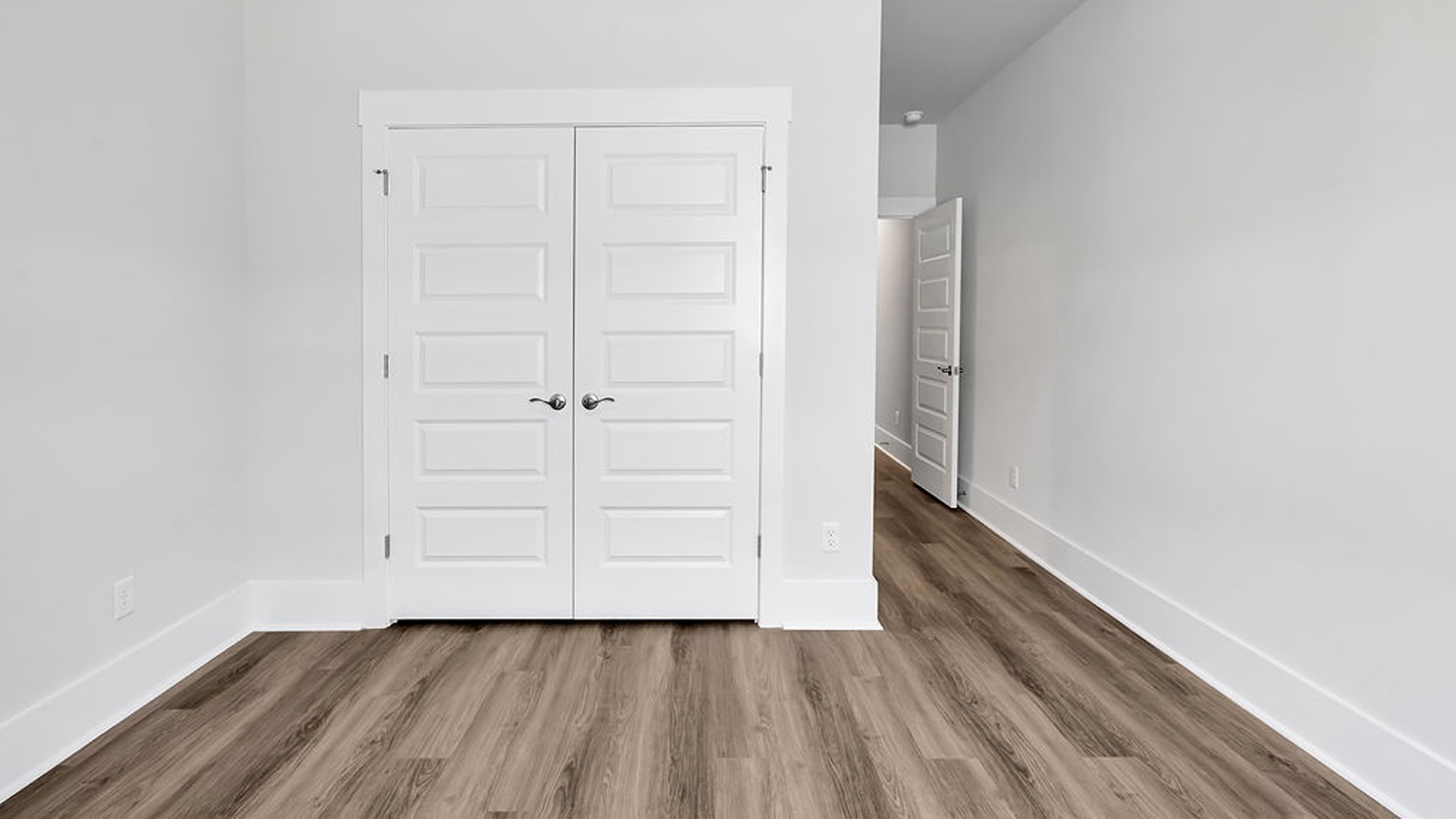 The main level also uniquely includes a private secondary bedroom away from the traffic, making it an ideal guest suite or quiet home office, conveniently adjacent to a full secondary bathroom and a nearby powder room.