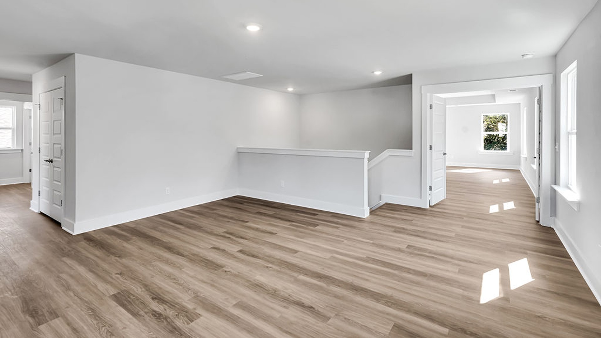 At the heart of the second floor lies a sprawling loft space, perfect for a media room or playroom.