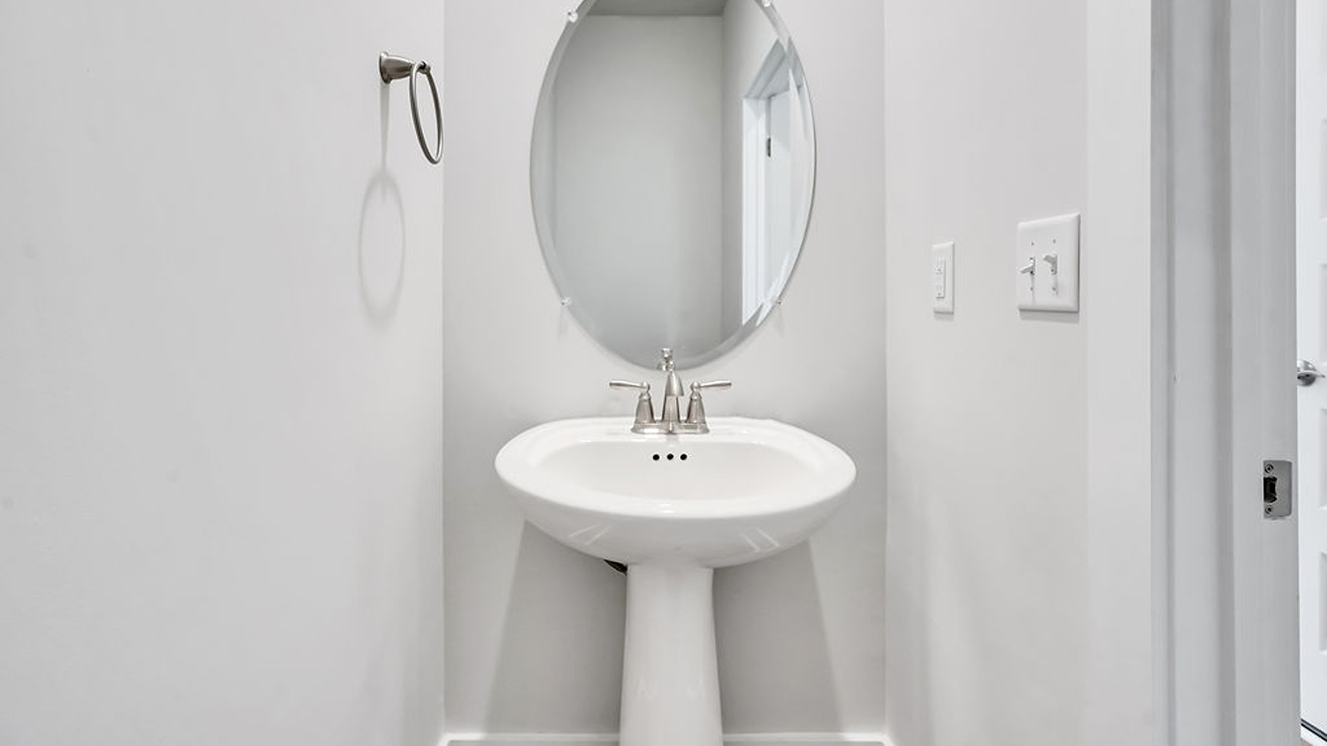 The main level also uniquely includes a private secondary bedroom away from the traffic, making it an ideal guest suite or quiet home office, conveniently adjacent to a full secondary bathroom and a nearby powder room.