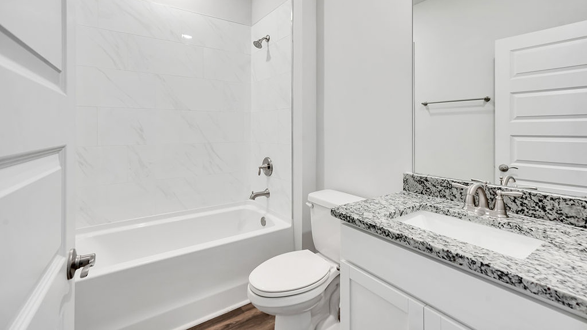 The main level also uniquely includes a private secondary bedroom away from the traffic, making it an ideal guest suite or quiet home office, conveniently adjacent to a full secondary bathroom and a nearby powder room.