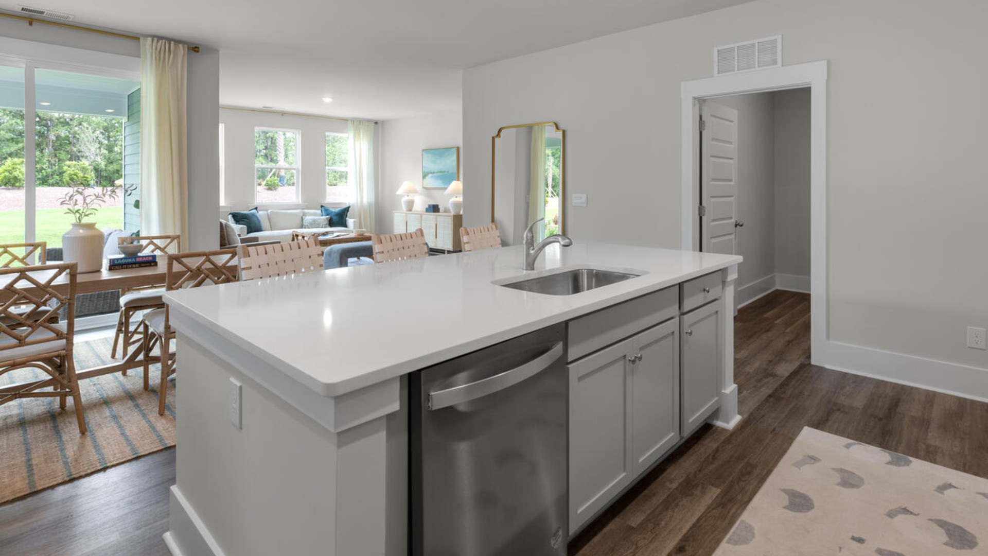 The kitchen features shaker-style cabinets, quartz countertops, and stainless steel appliances, which are sure to both turn heads and make meal prep easy. You’ll never be too far from the action with the living and dining area right there.