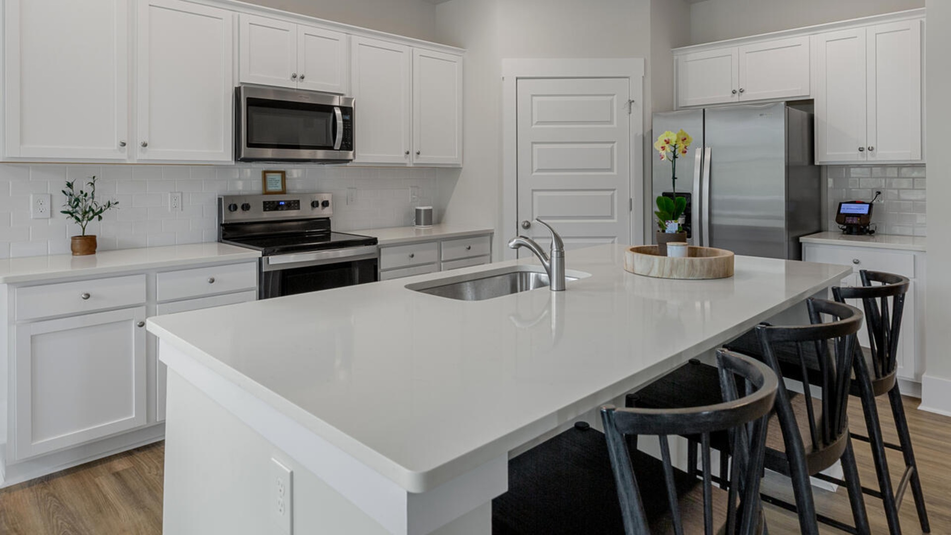 Enjoy coastal living at its best with a screened-in covered porch just off the open-concept kitchen, dining, and living areas — perfect for relaxing or entertaining. The kitchen boasts stainless steel appliances, a walk-in pantry, 4x12 subway tile, quartz countertops and a generous island that flows seamlessly into the main living area.