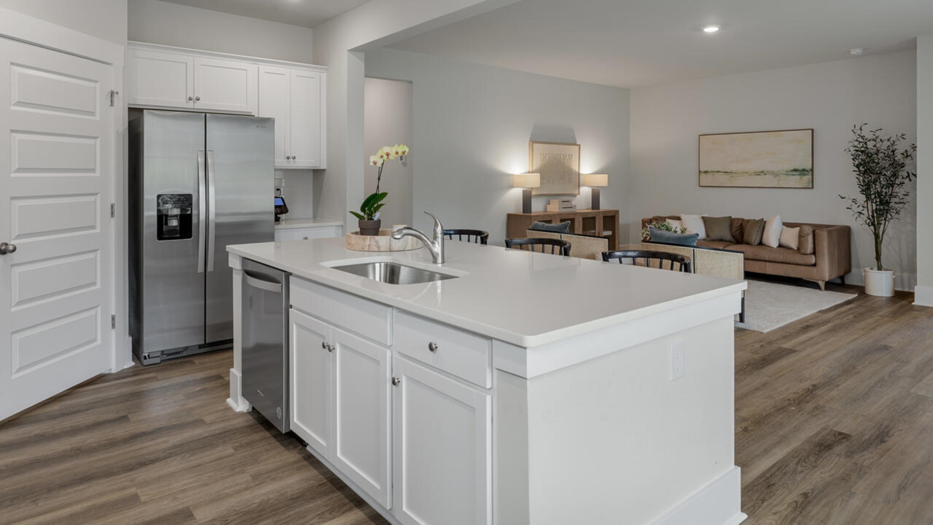 Enjoy coastal living at its best with a screened-in covered porch just off the open-concept kitchen, dining, and living areas — perfect for relaxing or entertaining. The kitchen boasts stainless steel appliances, a walk-in pantry, 4x12 subway tile, quartz countertops and a generous island that flows seamlessly into the main living area.