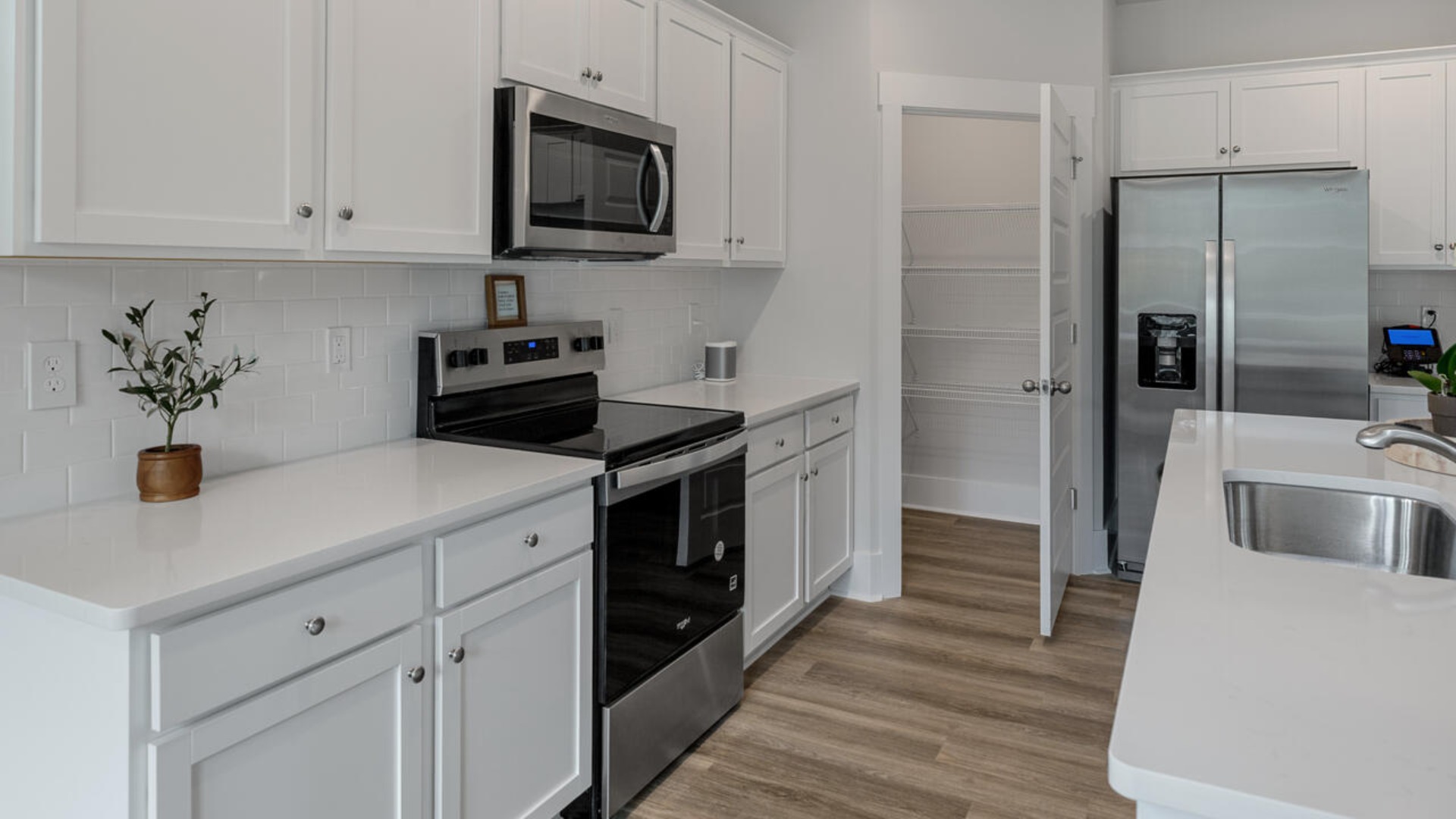 Enjoy coastal living at its best with a screened-in covered porch just off the open-concept kitchen, dining, and living areas — perfect for relaxing or entertaining. The kitchen boasts stainless steel appliances, a walk-in pantry, 4x12 subway tile, quartz countertops and a generous island that flows seamlessly into the main living area.