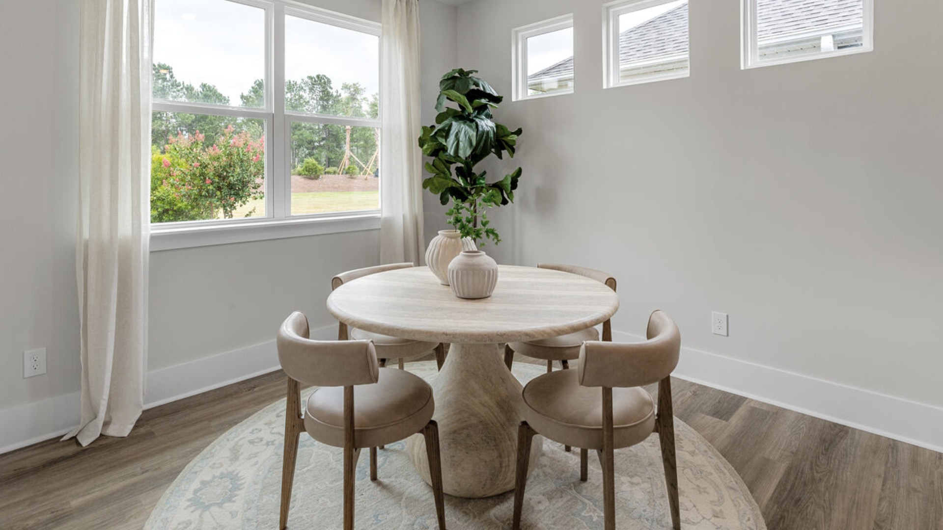 Enjoy coastal living at its best with a screened-in covered porch just off the open-concept kitchen, dining, and living areas — perfect for relaxing or entertaining. The kitchen boasts stainless steel appliances, a walk-in pantry, 4x12 subway tile, quartz countertops and a generous island that flows seamlessly into the main living area.