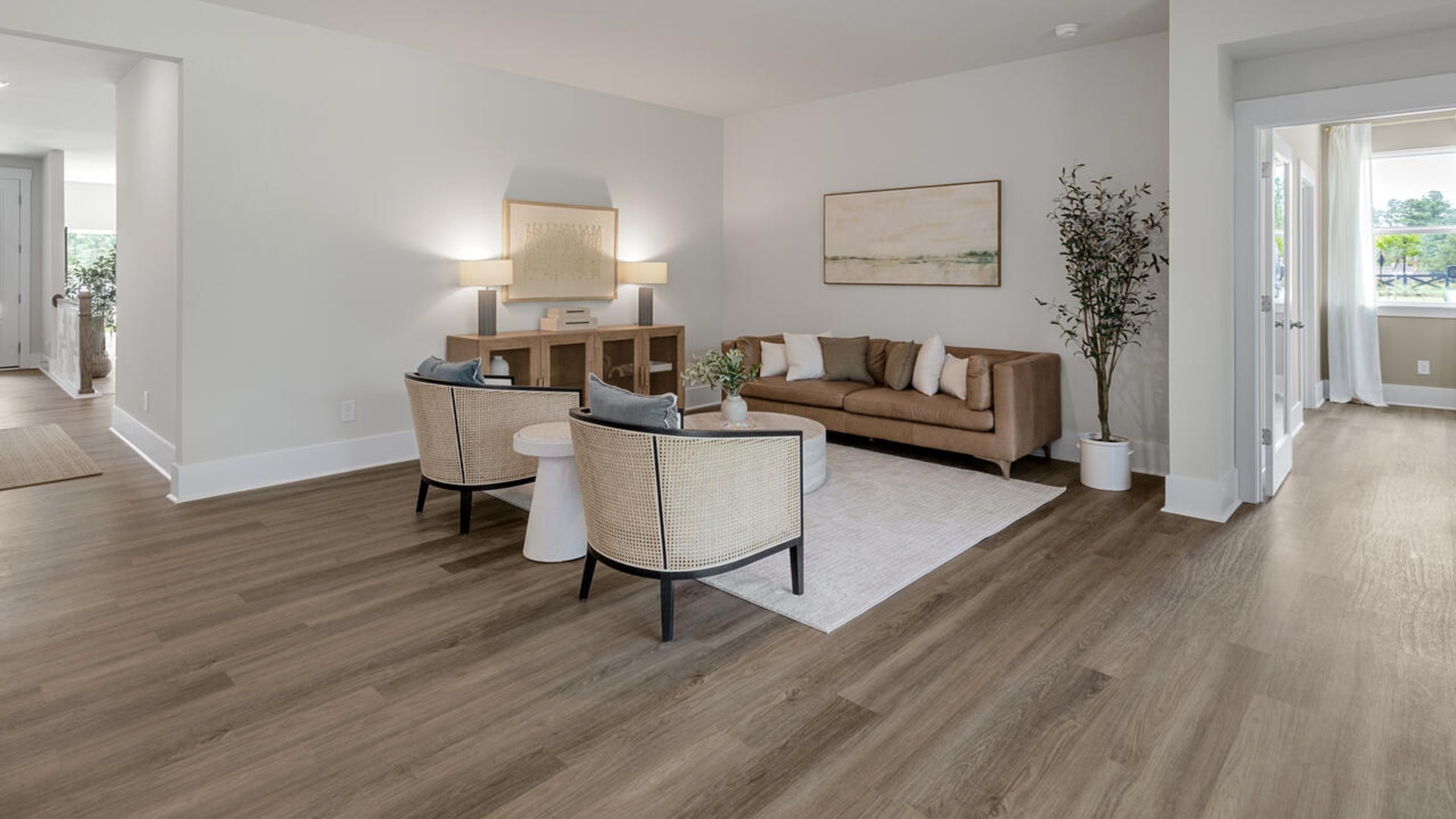 Enjoy coastal living at its best with a screened-in covered porch just off the open-concept kitchen, dining, and living areas — perfect for relaxing or entertaining. The kitchen boasts stainless steel appliances, a walk-in pantry, 4x12 subway tile, quartz countertops and a generous island that flows seamlessly into the main living area.