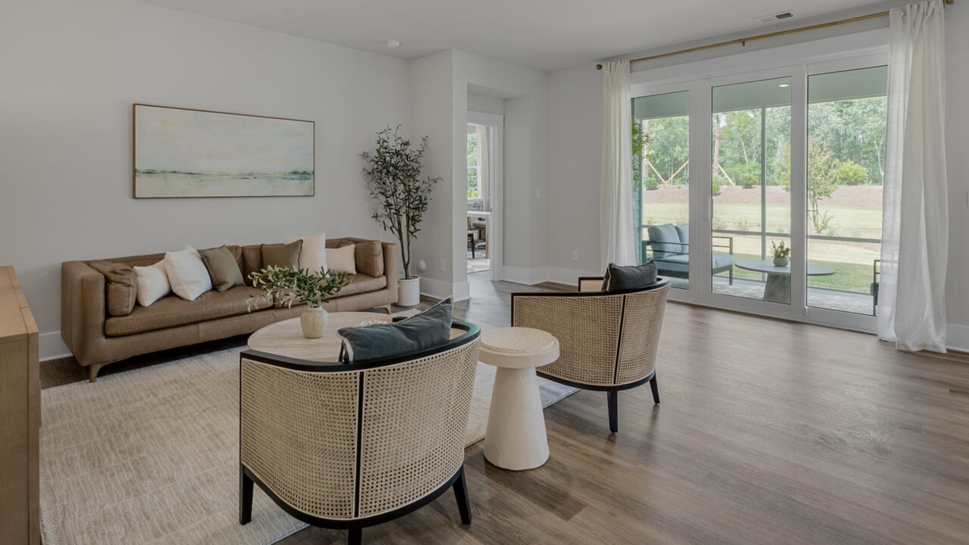 Enjoy coastal living at its best with a screened-in covered porch just off the open-concept kitchen, dining, and living areas — perfect for relaxing or entertaining. The kitchen boasts stainless steel appliances, a walk-in pantry, 4x12 subway tile, quartz countertops and a generous island that flows seamlessly into the main living area.