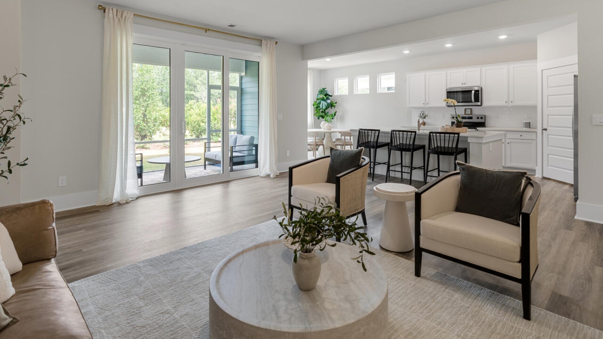 Enjoy coastal living at its best with a screened-in covered porch just off the open-concept kitchen, dining, and living areas — perfect for relaxing or entertaining. The kitchen boasts stainless steel appliances, a walk-in pantry, 4x12 subway tile, quartz countertops and a generous island that flows seamlessly into the main living area.