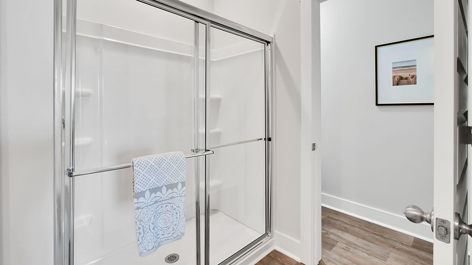 Your primary suite features a 5-foot tiled shower with a frameless glass door and dual vanities for a touch of everyday luxury. This beautiful homesite backs up to a tree line and is on a street that ends in a cul-de-sac.