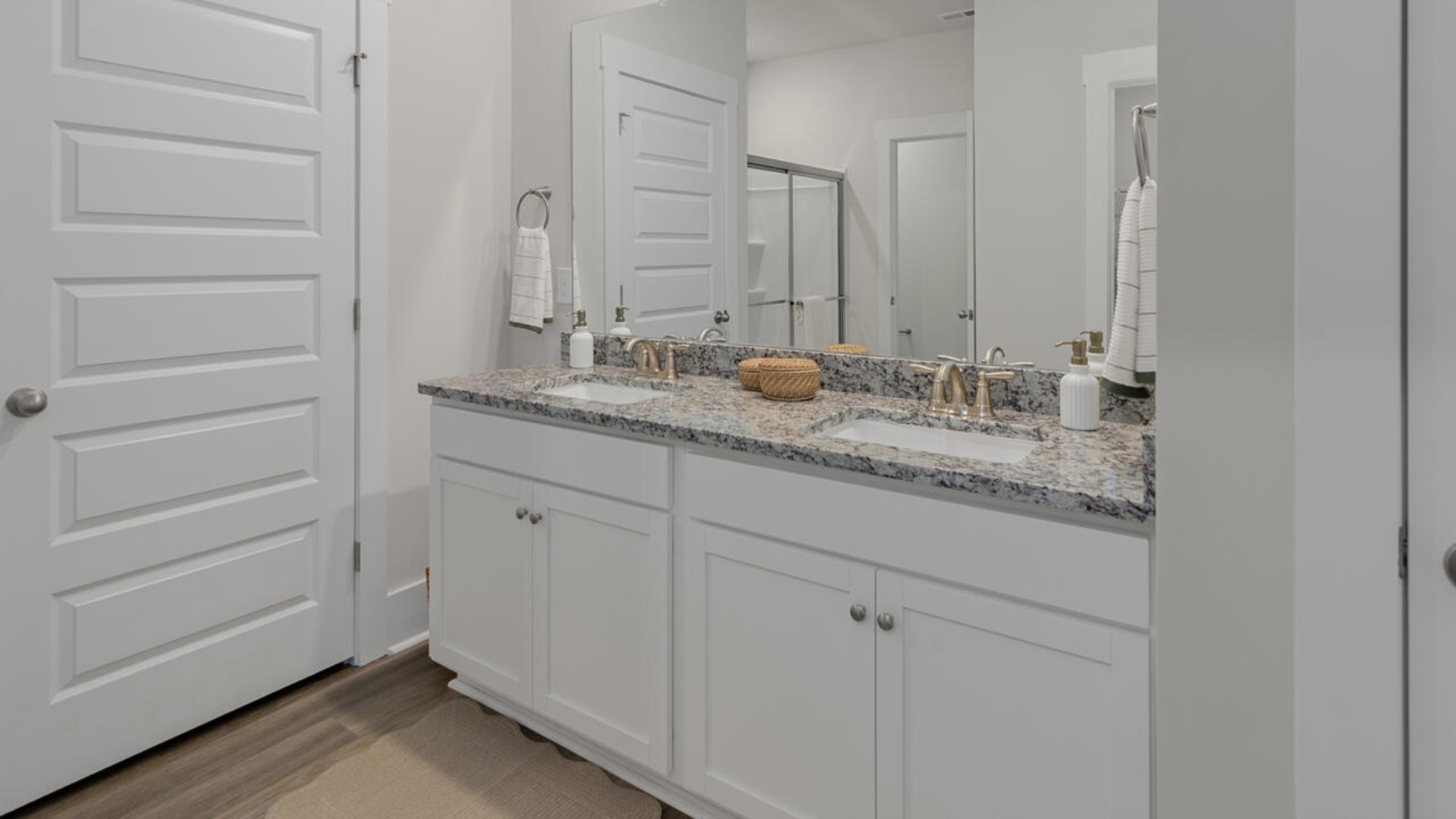 The spacious primary bedroom has a walk-in closet, garden tub, and double bowl vanities